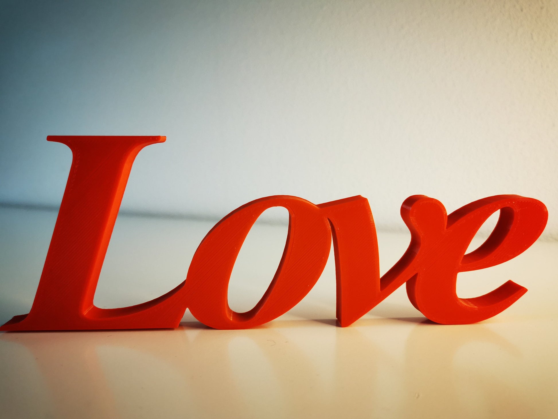 Love word sign, abstract modern design, red, 3D printed, elegant tabledecoration living room, home decor