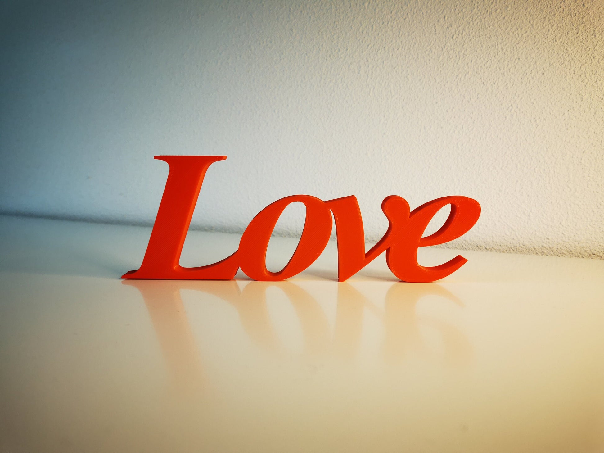 Love word sign, abstract modern design, red, 3D printed, elegant tabledecoration living room, home decor