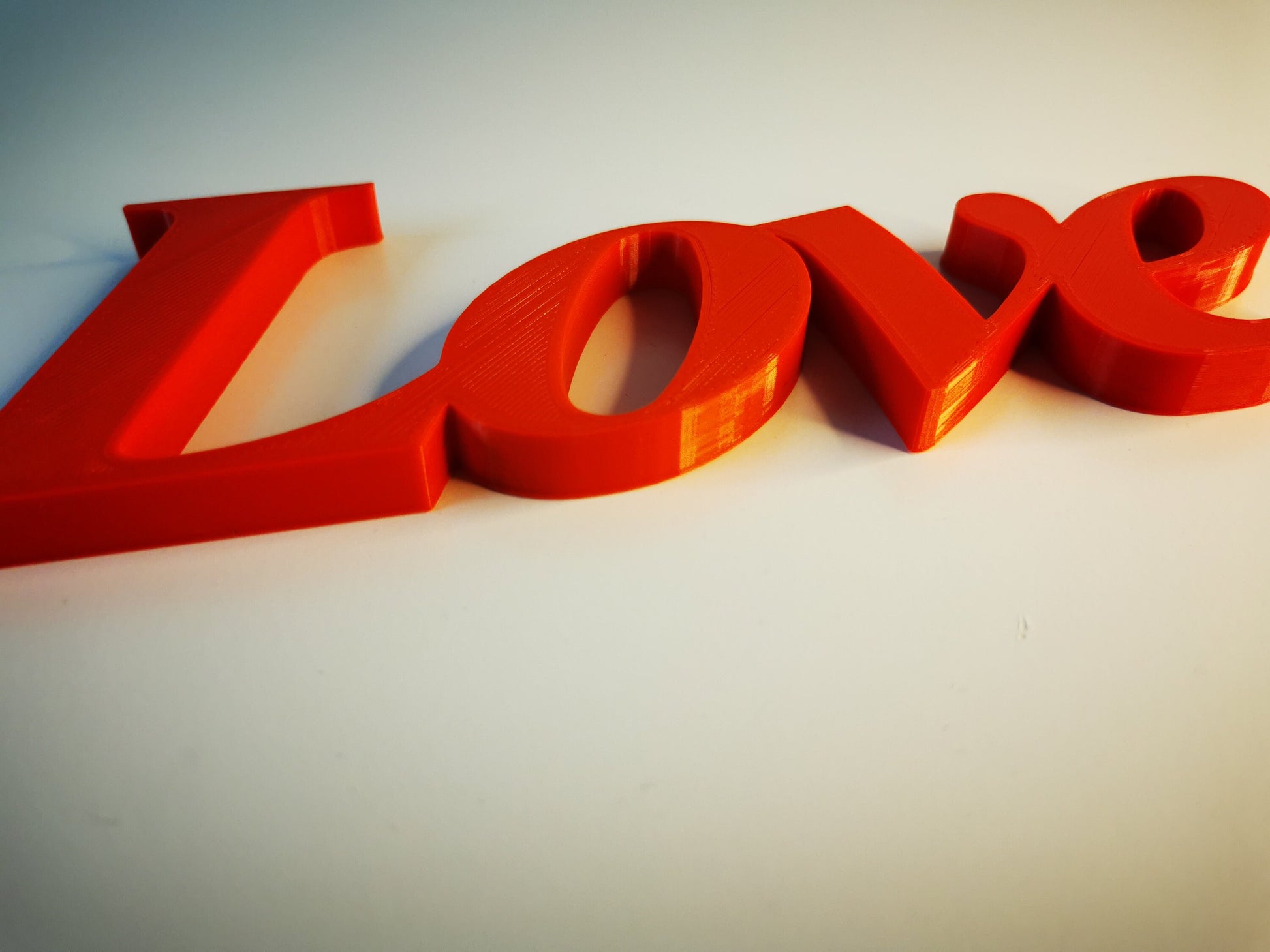 Love word sign, abstract modern design, red, 3D printed, elegant tabledecoration living room, home decor